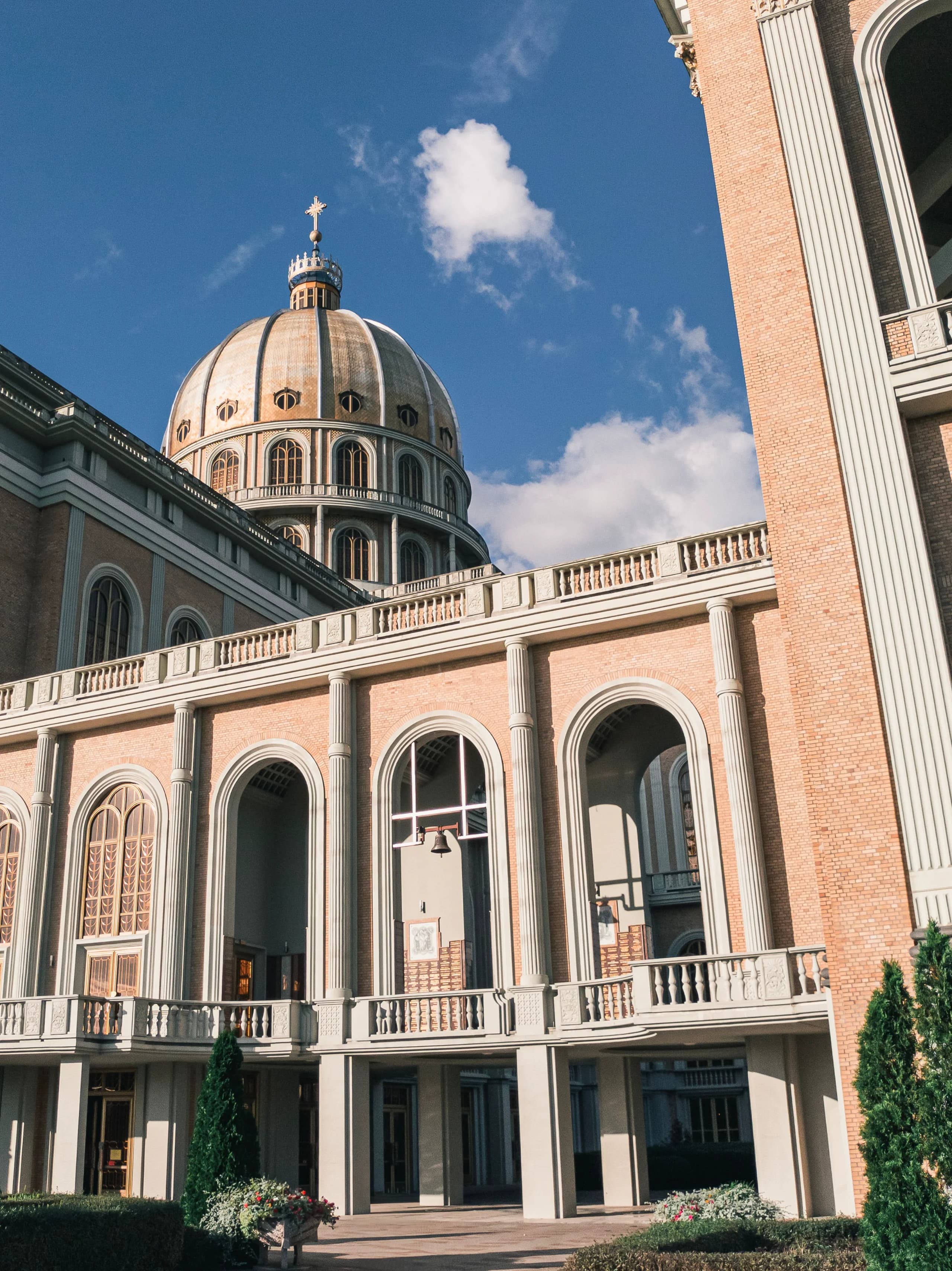 Stunning view of a cathedral's dome and arches under a clear blue sky.