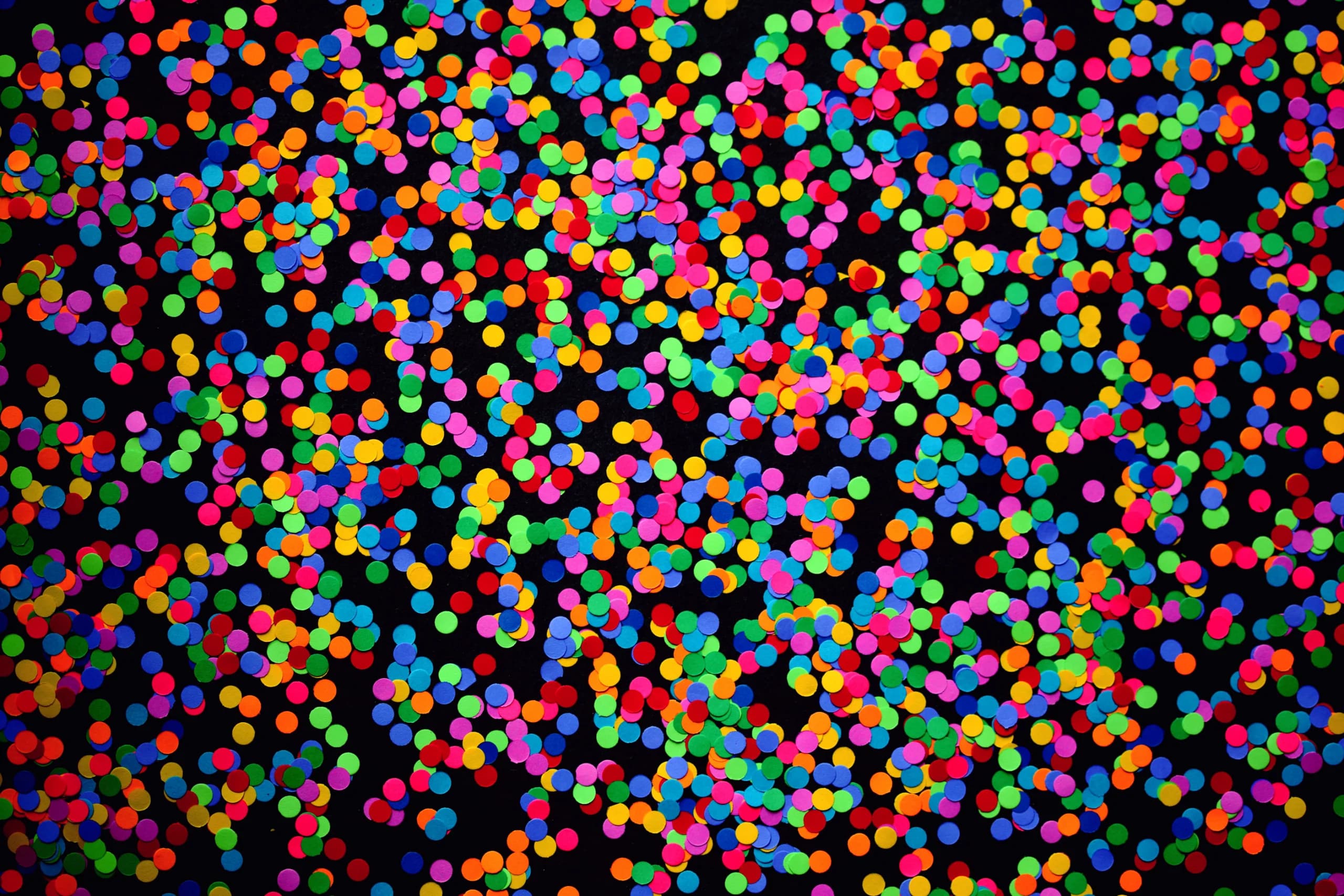 A vibrant, colorful confetti spread against a dark backdrop, perfect for celebrations.