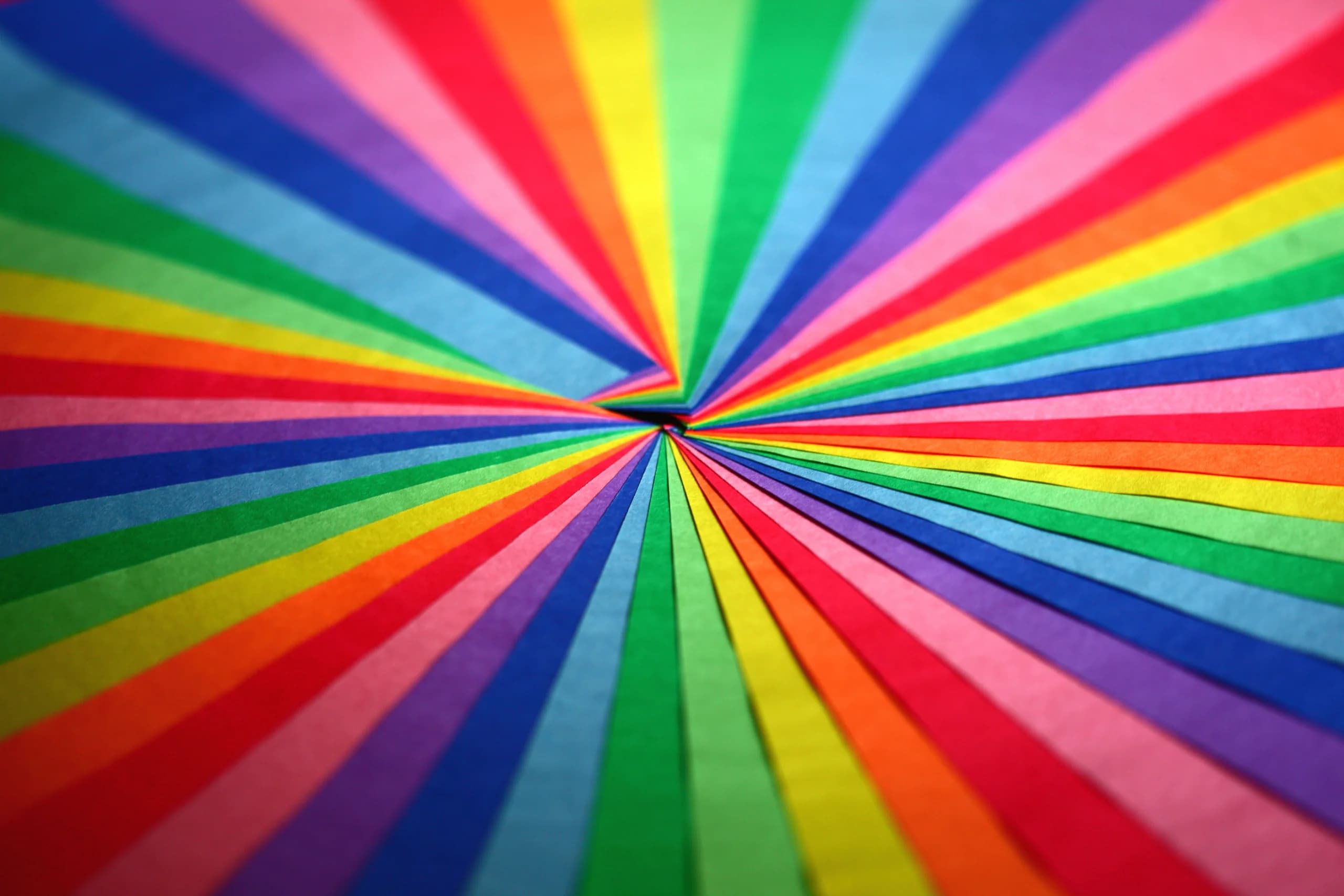Explosive display of vibrant colored paper forming a symmetrical pattern.